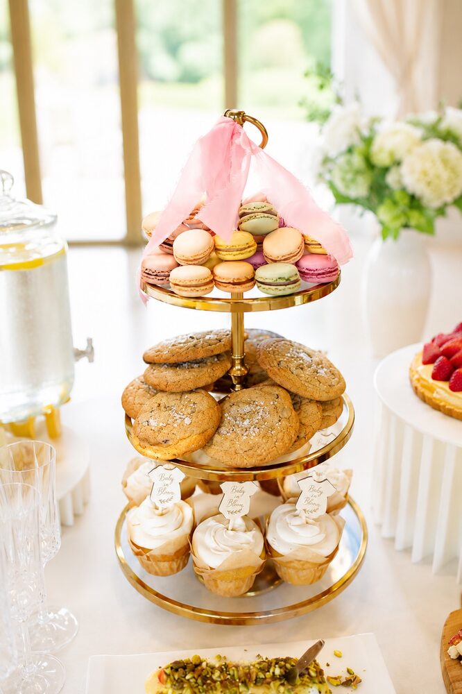 Three-tier dessert tower of macarons, cookies and cupcakes